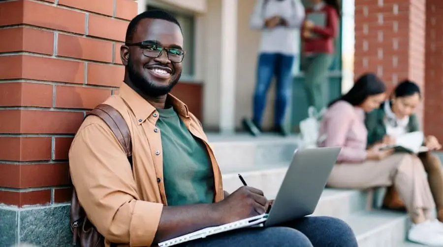 College student with laptop and notebook